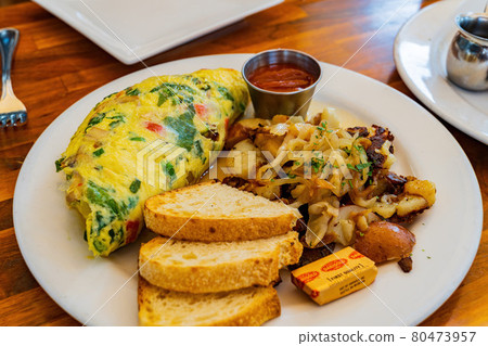 Close up shot of a plate of Omelette with bread and potato Close up shot of a plate of Omelette with bread and potato 80473957