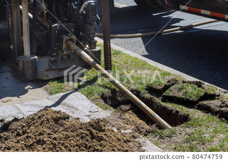 Low angle view of trenchless laying of communications, pipes and water pipes with horizontal directional drilling technology machine work process Low angle view of trenchless laying of communications, pipes and water pipes with horizontal directional drilling technology machine work process 80474759