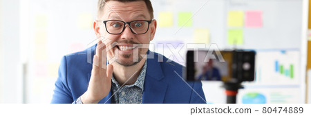 Smiling businessman tells business secrets and coach training Smiling businessman tells business secrets and coach training 80474889