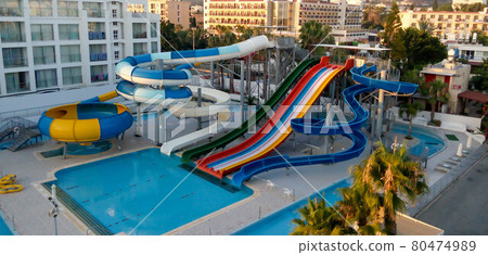 Water park with colorful slides and pools in the early morning 80474989