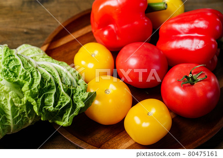 lettuce, yellow and red tomatoes and bell pepper with water drops. cucumbers. 80475161