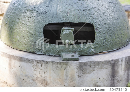 Fortified military firing point with a machine gun from the WWII Fortified military firing point with a machine gun from the WWII 80475340