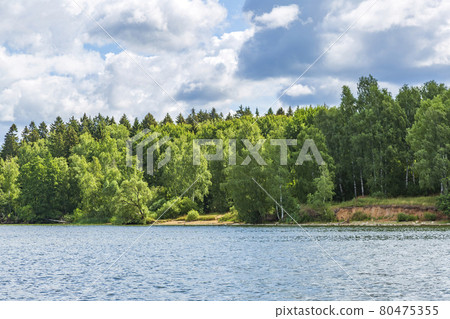 Picturesque lake in the countryside on a sunny summer day Picturesque lake in the countryside on a sunny summer day 80475355
