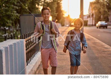 School boys running to school. School boys having fun after school. 80475690