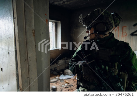 Military men with arms defending the building. Soldier stand guard securing territory looking around. 80476261