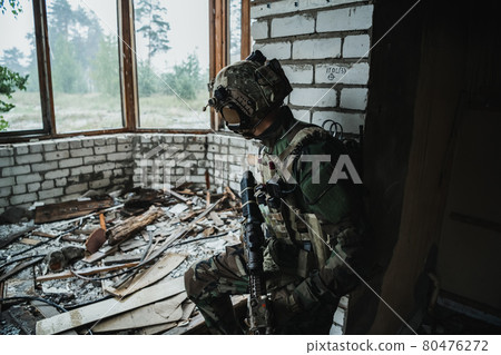 Soldier preparing tactical gear for action battle 80476272