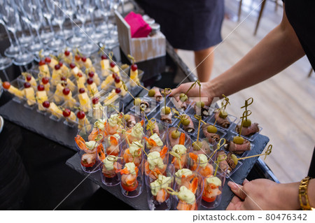 buffet table - a lot of canapes and sandwiches, shallow DOF. 80476342