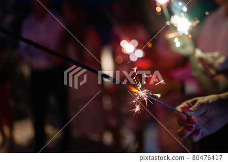 Picture showing group of friends having fun with sparklers. Picture showing group of friends having fun with sparklers. 80476417