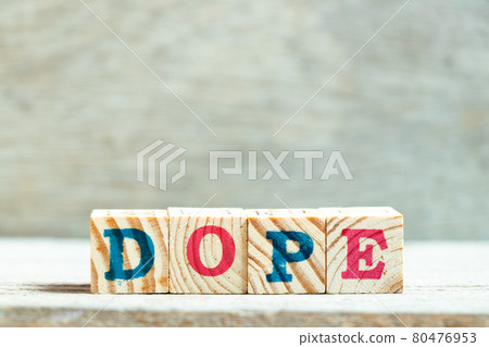 Alphabet letter block in word dope on wood background Alphabet letter block in word dope on wood background 80476953