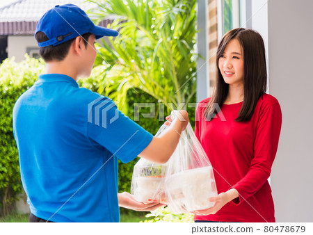 Delivery man making grocery service giving rice food boxes plastic bags to woman customer Delivery man making grocery service giving rice food boxes plastic bags to woman customer 80478679