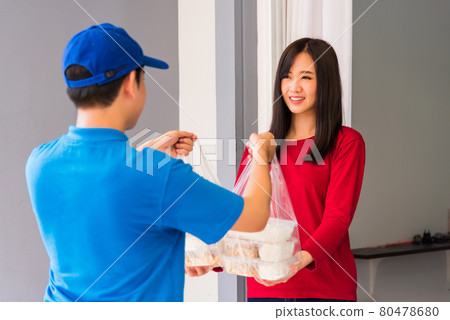Delivery man making grocery service giving rice food boxes plastic bags to woman customer 80478680