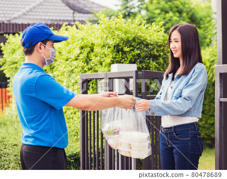 Delivery man making grocery giving rice food boxes plastic bags to woman customer receiving Delivery man making grocery giving rice food boxes plastic bags to woman customer receiving 80478689