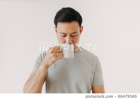 Man is drinking coffee or tea isolated on white background. Man is drinking coffee or tea isolated on white background. 80479560