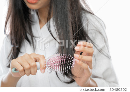close up of a woman using comb with with tousled hair close up of a woman using comb with with tousled hair 80480202