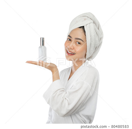 beautiful woman in towel with gesture presenting something while holding perfume bottle beautiful woman in towel with gesture presenting something while holding perfume bottle 80480583