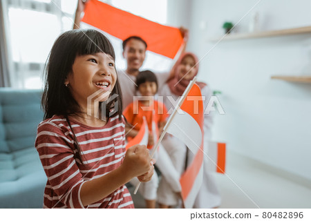 excited indonesian little girl supporter while watching sport match at television excited indonesian little girl supporter while watching sport match at television 80482896
