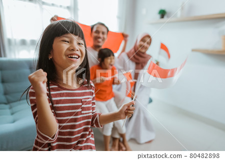 excited indonesian little girl supporter while watching sport match at television excited indonesian little girl supporter while watching sport match at television 80482898