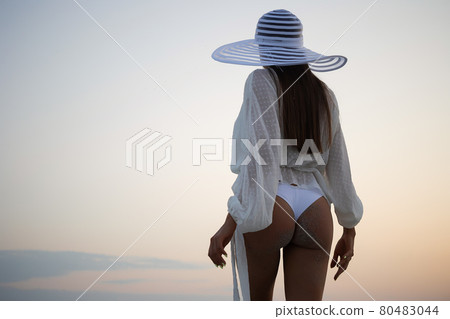 Stylish sensual woman in beachwear and hat 80483044