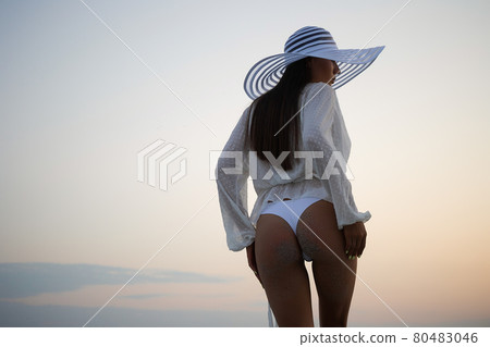 Stylish sensual woman in beachwear and hat 80483046