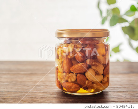 Honey and nuts in jar., Stock image