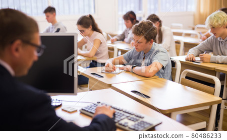Teenage students working at class during lesson Teenage students working at class during lesson 80486233