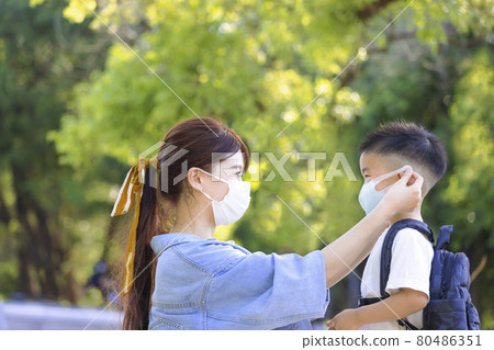 Mother help  son wearing medical mask protection 80486351