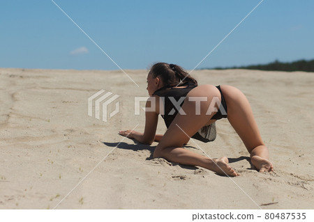 Seductive woman in lingerie on sandy beach Seductive woman in lingerie on sandy beach 80487535