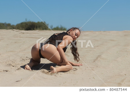 Seductive woman in lingerie on sandy beach 80487544