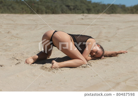 Seductive woman in lingerie on sandy beach 80487598