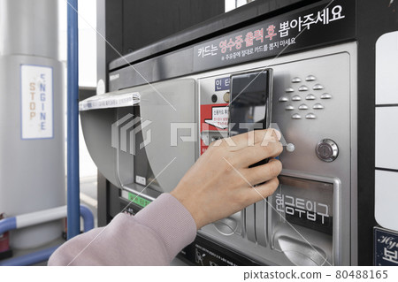 hand paying at gas station with smartphone easy payment hand paying at gas station with smartphone easy payment 80488165