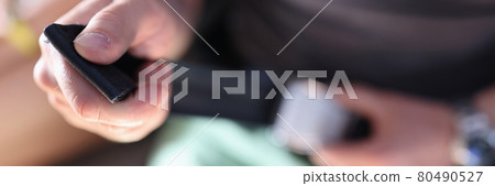 Man fixes his seat belt in airplane closeup 80490527