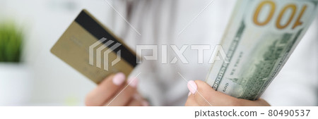 In women hands, plastic bank card and one hundred dollar bills 80490537