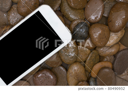 smart phone on the gravel. 80490932