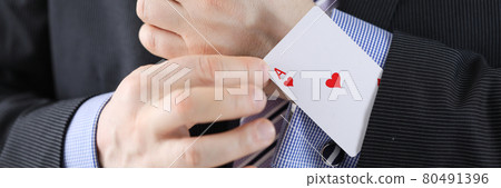 Businessman pulling ace out of his jacket pocket closeup 80491396