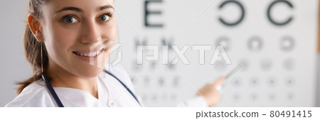 Woman doctor checking eyesight using table in clinic 80491415