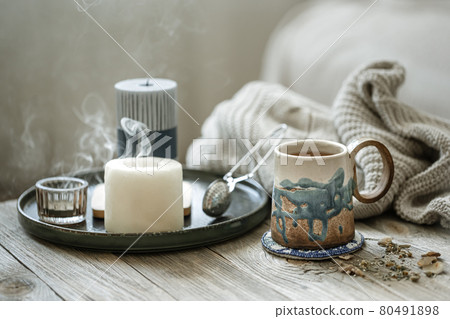 Home scandinavian style still life with a cup of tea and candles. Home scandinavian style still life with a cup of tea and candles. 80491898