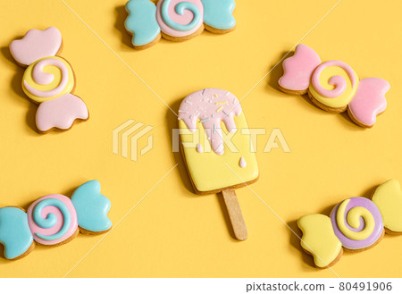 Bright cookies in glaze on a yellow background. 80491906