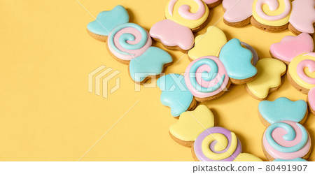 Bright cookies in glaze on a yellow background copy space. 80491907