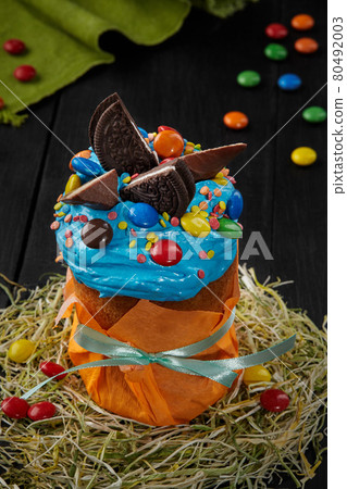 Easter cake with blue whipped egg whites icing and sweets Easter cake with blue whipped egg whites icing and sweets 80492003