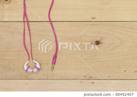 earphones on the wooden board 80492407