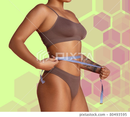 Young tanned slim girl taking measurements of her body isolated on colored background. Collage. 80493595