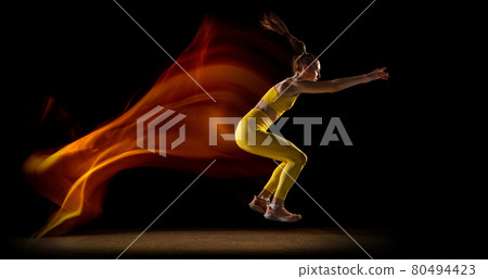 Flyer. Young woman, female athlete training isolated over black studio background in mixed neon lights. Side view Flyer. Young woman, female athlete training isolated over black studio background in mixed neon lights. Side view 80494423