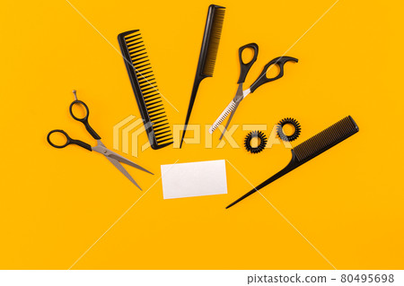 Hairdresser tools on yellow background with copy space, top view, flat lay. 80495698