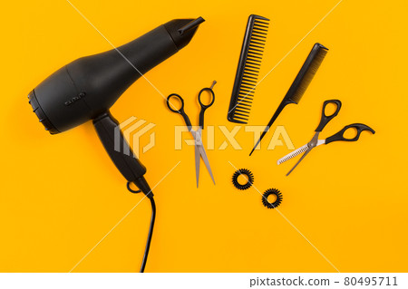 Hairdresser set with various accessories on orange and blue background 80495711