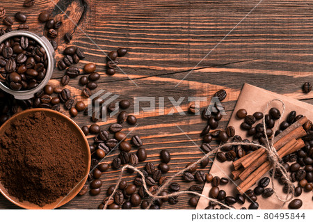 Coffee beans, cinnamon sticks and ground coffee on rustic wooden Coffee beans, cinnamon sticks and ground coffee on rustic wooden 80495844