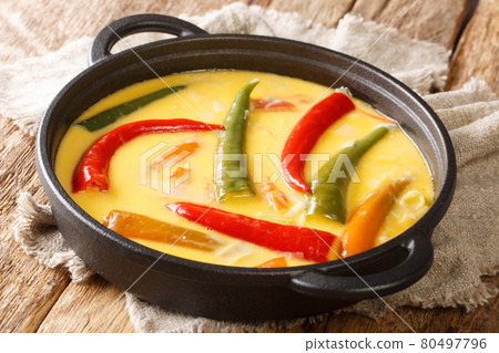 Green and red chillies abound in Ema datshi it is made from hot chili peppers and yak cheese closeup in the pan. horizontal 80497796
