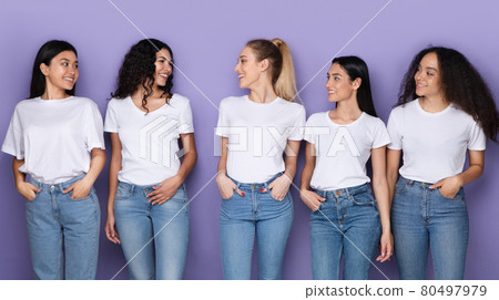Multiethnic Millennials Ladies Looking At Each Other Standing, Purple Background Multiethnic Millennials Ladies Looking At Each Other Standing, Purple Background 80497979