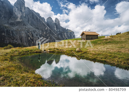 Woman enjoying Passo Gardena and Sella group mountains in Dolomites, south Tyrol, Italy, Europe 80498709