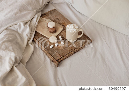 coffee with marshmallows and macaroons on a wooden tray, in bed. Aesthetically beautiful frame. Desserts in bed. hot chocolate with marshmallows. Cozy and warm day in bed coffee with marshmallows and macaroons on a wooden tray, in bed. Aesthetically beautiful frame. Desserts in bed. hot chocolate with marshmallows. Cozy and warm day in bed 80499297