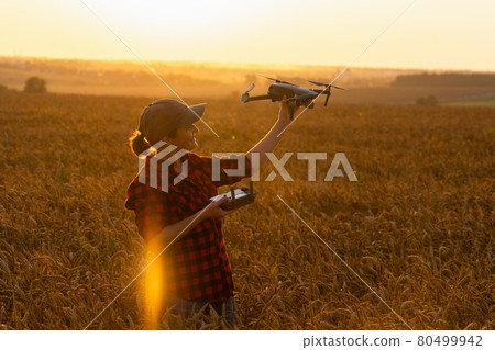 Woman farmer with drone  80499942